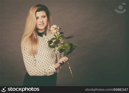 International women or mother day. Beautiful portrait of pretty woman blonde hair with white rose flower. Dark day background. Pretty woman with white rose flower