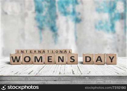 International Womens day sign on a wooden table with a blurry background
