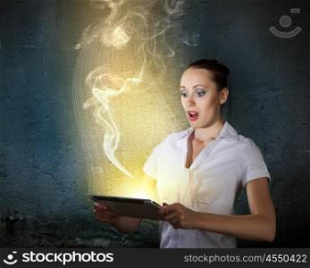 Internet addiction. Young businesswoman looking astonished into tablet pc