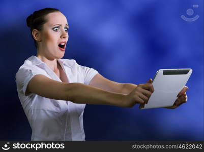 Internet addiction. Young pretty surprised woman using tablet pc