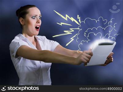 Internet addiction. Young pretty surprised woman using tablet pc