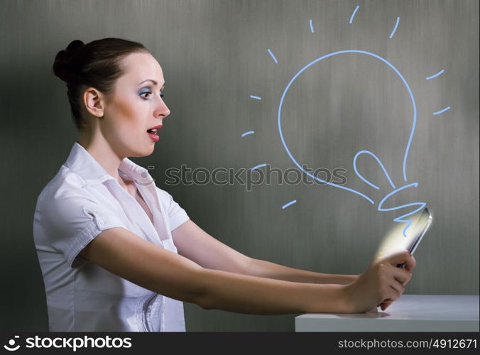 Internet addiction. Young pretty surprised woman using tablet pc