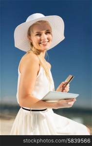 internet and lifestyle concept - beautiful woman in hat doing online shopping outdoors. woman in hat doing online shopping outdoors