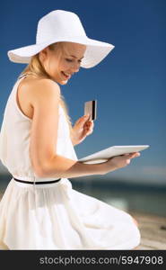 internet and lifestyle concept - beautiful woman in hat doing online shopping outdoors. woman in hat doing online shopping outdoors