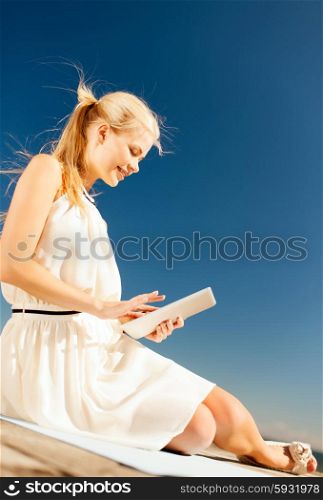 internet and lifestyle - young woman working with tablet pc outdoors. beautiful smiling woman with tablet pc outdoors