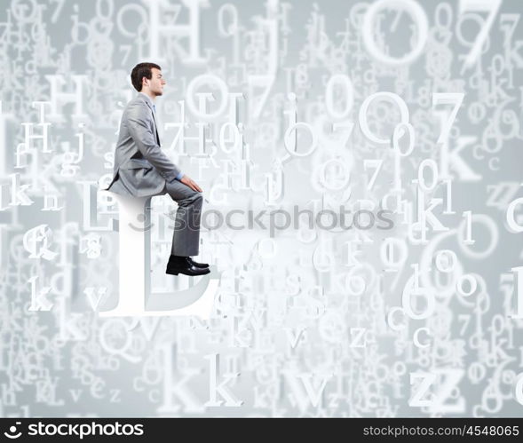 Internet communication. Young businessman sitting on huge white letter. Email concept