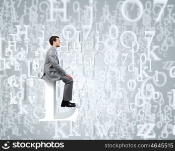 Internet communication. Young businessman sitting on huge white letter. Email concept