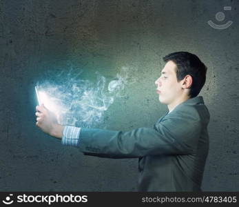 Internet communication. Young man sitting at table and using laptop