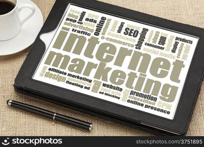 internet marketing - word cloud on a digital tablet with a cup of coffee