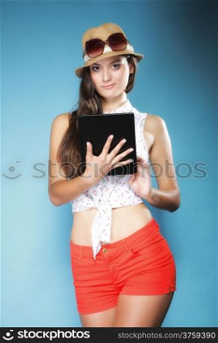 Internet modern lifestyle concept. Young summer girl in hat using tablet computer reading. Latin female with e-book reader touchpad pc.