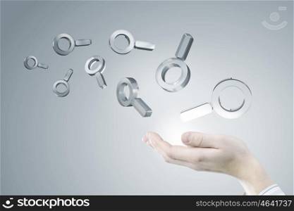 Internet search icon. Businessman hand holding search glass icons in palm