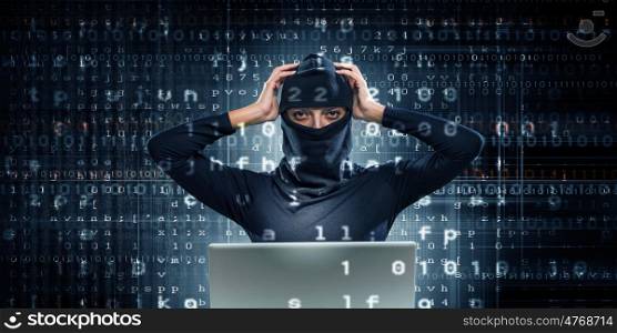 Internet security concept. Hacker woman in dark clothes using laptop against digital background