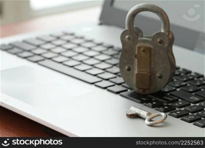 Internet security concept-old padlock and key on laptop computer keyboard