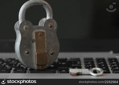 Internet security concept-old padlock and key on laptop computer keyboard