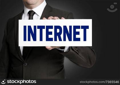 Internet sign is held by businessman.. Internet sign is held by businessman