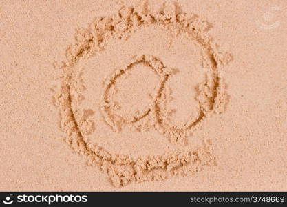 Internet @ sign written on wet sand