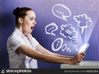 Internet user. Young attractive emotional woman using tablet pc