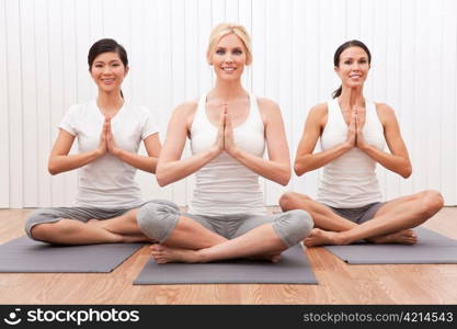 Interracial Group of Three Beautiful Women In Yoga Position