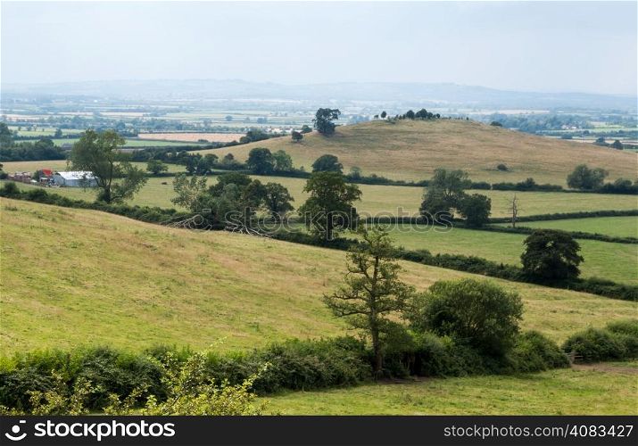 Intersecting fields, hedges and farms looking out from Quainton Hill, Buckinghamshire, England towards Grange Hill
