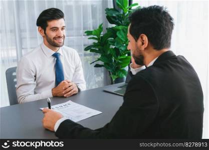 Interviewing job applicant in office with resume paper. Candidate wear suit for formal conversation with interviewer. Recruitment process with question about career and work experience. Fervent. Interviewing job applicant in office with resume paper. Fervent