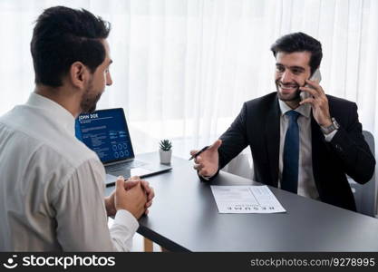 Interviewing job applicant in office with resume paper. Candidate wear suit for formal conversation with interviewer. Recruitment process with question about career and work experience. Fervent. Interviewing job applicant in office with resume paper. Fervent