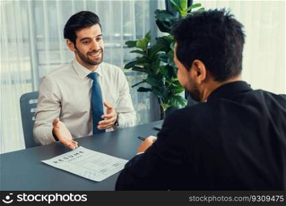 Interviewing job applicant in office with resume paper. Candidate wear suit for formal conversation with interviewer. Recruitment process with question about career and work experience. Fervent. Interviewing job applicant in office with resume paper. Fervent