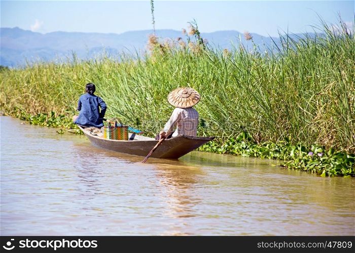 Inthas travel on boat in Inle, Myanmar. Travel by boat is the major transportation mean both local and tourists in Inle lake.