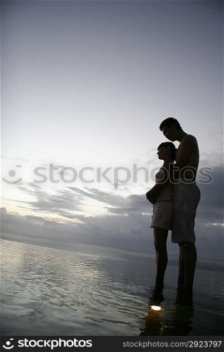 Intimate Couple Embrace at the edge of water