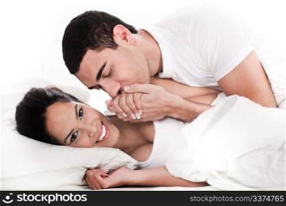 Intimate young couple in bed over white background