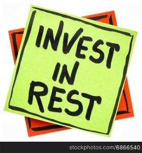 Invest in rest reminder or advice - handwriting in black ink on an isolated sticky note