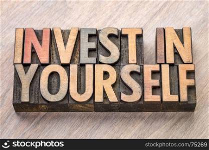 invest in yourself word abstract in vintage letterpress wood type