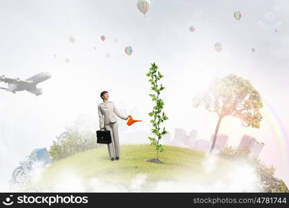 Invest right to get income. Young businesswoman watering green plant with can