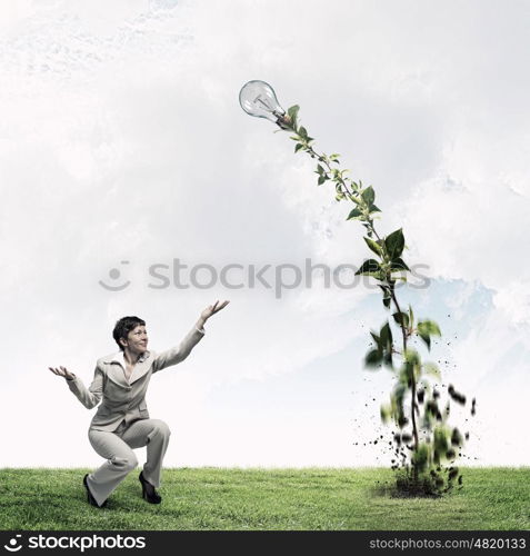 Invest right to get income. Young businesswoman watering green plant with can