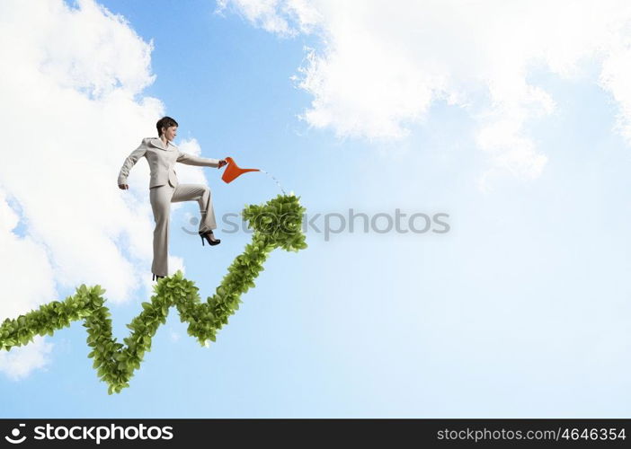 Invest to increase your incomes. Businesswoman with can walking on green growing graph