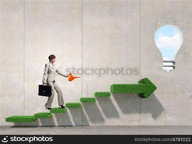 Invest to increase your incomes. Businesswoman with can walking on green growing graph