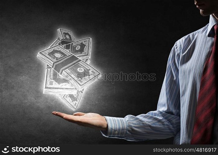 Invest your money right. Businessman hand holding drawn banknotes in palm on dark background