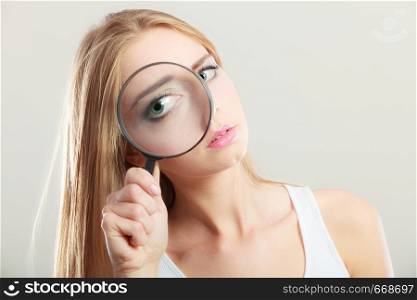Investigation exploration education concept. Closeup woman face, girl holding on eye magnifying glass loupe