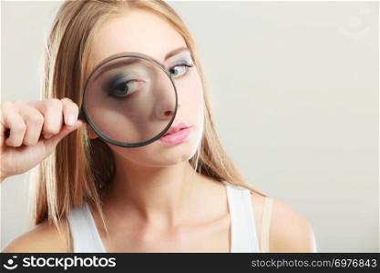 Investigation exploration education concept. Closeup woman face, girl holding on eye magnifying glass loupe