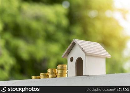 Investment buy house property home loan mortgage advice real estate marketing interest asset with golden money coin stack.Saving Money Concept. Woman hand holding budget buy house real estate agent.