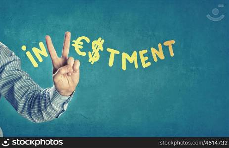Investment concept. Word investment with fingers instead of letter V