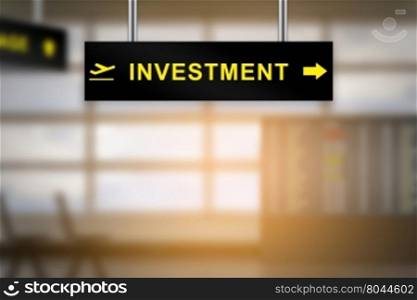 investment on airport sign board with blurred background and copy space