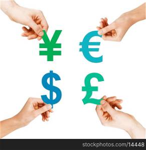 investment, stock market and exchange concept - four hands holding currency symbols
