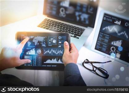 Investor analyzing stock market report and financial dashboard with business intelligence (BI), with key performance indicators (KPI).Man working new start up project in modern studio.Digital tablet laptop computer design.
