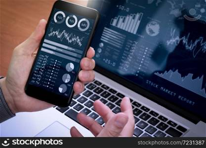 Investor analyzing stock market report and financial dashboard with business intelligence (BI), with key performance indicators (KPI).Businessman using smart phone with laptop computer.