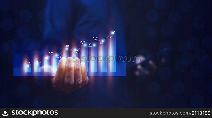 Investor or Trader holding digital graph on technology visual screen for trading online stock market forex or stock exchange