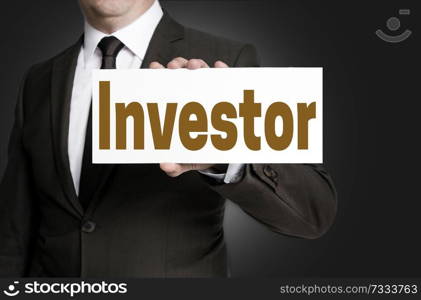 investor placard is held by businessman background.. investor placard is held by businessman background