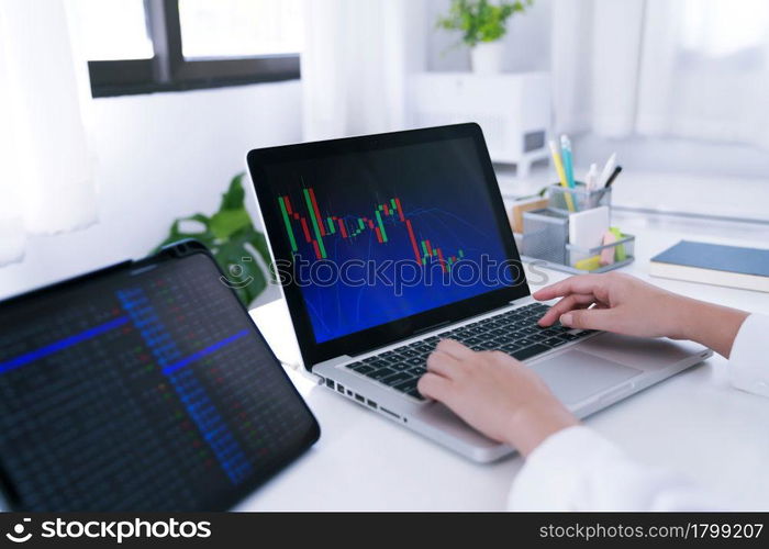 Investor trading crypto currencies online work at home. chart suitable for Stock market forex or cryptography trading financial investment graphs Finance Economy Trading Stock on computer screen