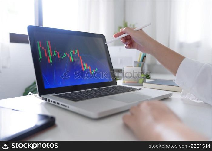 Investor trading crypto currencies online work at home. chart suitable for Stock market forex or cryptography trading financial investment graphs Finance Economy Trading Stock on computer screen