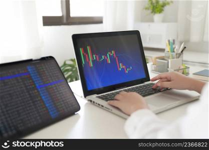 Investor trading crypto currencies online work at home. chart suitable for Stock market forex or cryptography trading financial investment graphs Finance Economy Trading Stock on computer screen