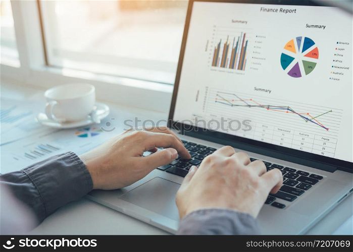 Investors are using laptop computers to analyze graphs in the morning.